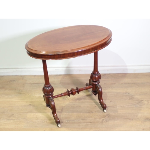 408 - A Victorian mahogany oval Occasional Table mounted upon turned cheval supports and leafage carved sc... 