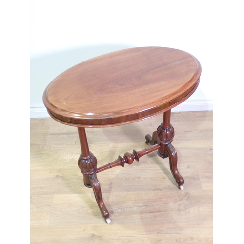 408 - A Victorian mahogany oval Occasional Table mounted upon turned cheval supports and leafage carved sc... 