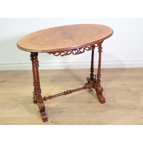 409 - A Victorian walnut oval Occasional Table mounted upon twisted and tuned double end supports united b... 