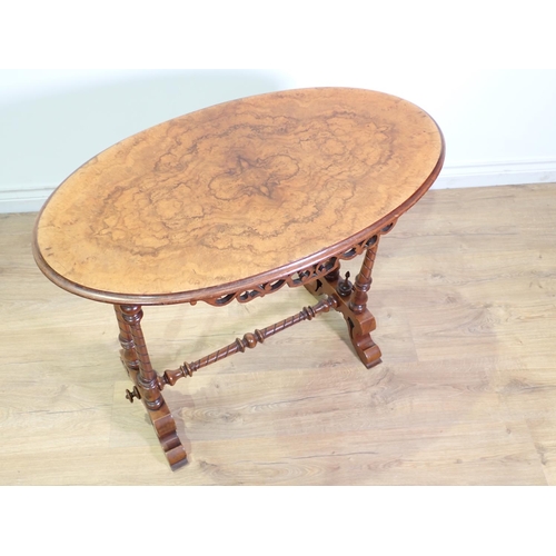 409 - A Victorian walnut oval Occasional Table mounted upon twisted and tuned double end supports united b... 