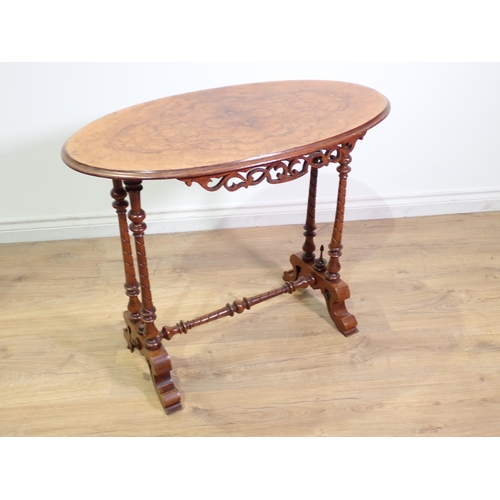 409 - A Victorian walnut oval Occasional Table mounted upon twisted and tuned double end supports united b... 