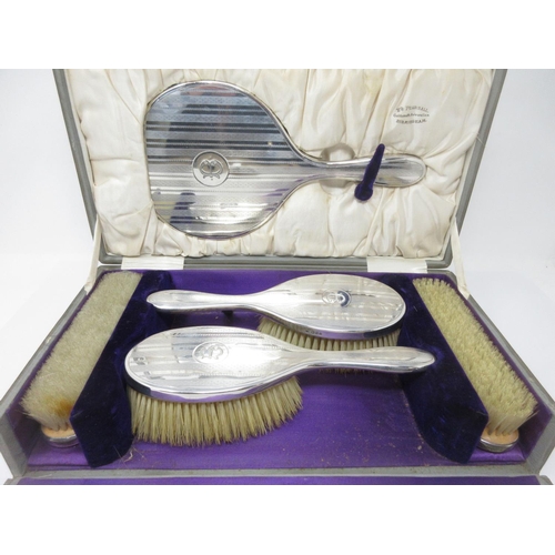 41 - A George V silver mounted five-piece Dressing Table Set with engine turning and initial B, London 19... 