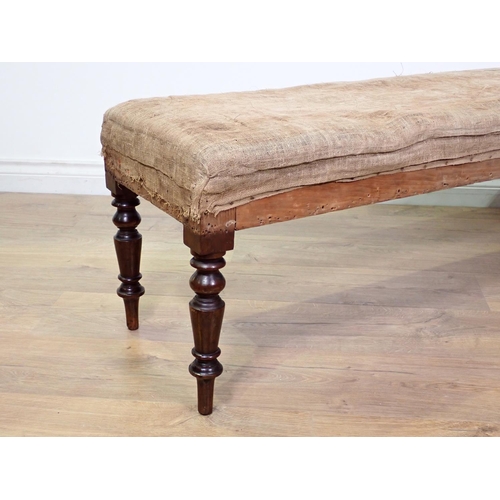 422 - A Victorian mahogany Footstool on turned supports in need of re-upholstery 4ft 4in W x 1ft 4in H