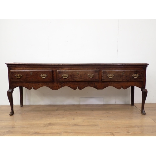 435 - An 18th Century oak Dresser Base with three drawers above a shaped frieze on cabriole front legs, 6f... 