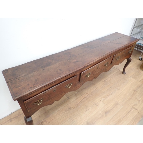 435 - An 18th Century oak Dresser Base with three drawers above a shaped frieze on cabriole front legs, 6f... 