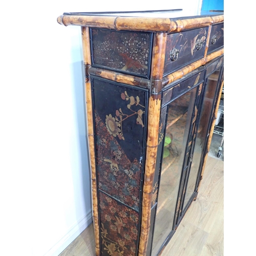 437 - A 19th Century bamboo and ebonised and glazed two door Bookcase enclosing painted fixed shelves fitt... 