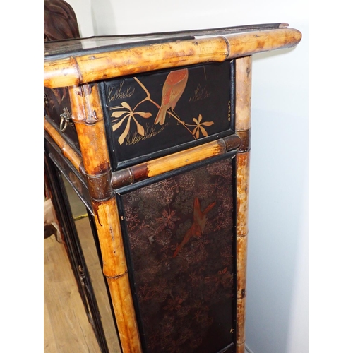 437 - A 19th Century bamboo and ebonised and glazed two door Bookcase enclosing painted fixed shelves fitt... 