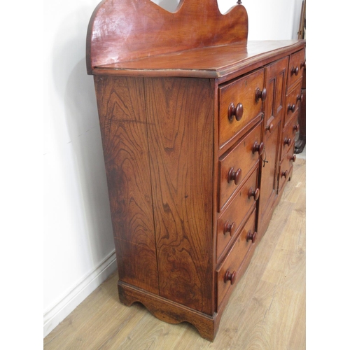 449 - A 19th Century elm Dresser with raised back, fitted central panelled door, flanked by eight drawers ... 