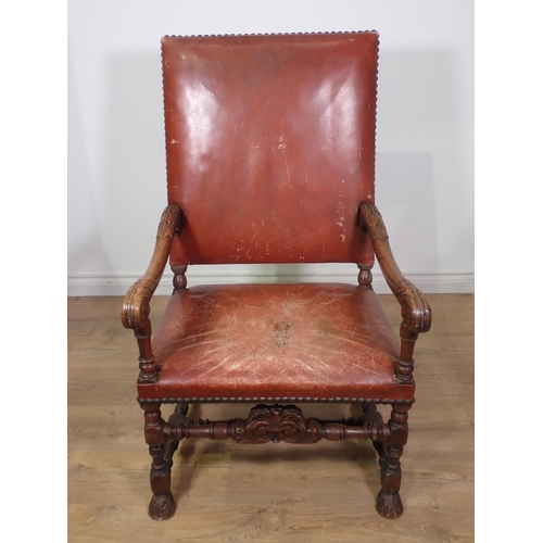 451 - A 19th Century carved Elbow Chair with leather upholstered back and seat, acanthus leaf carving to t... 