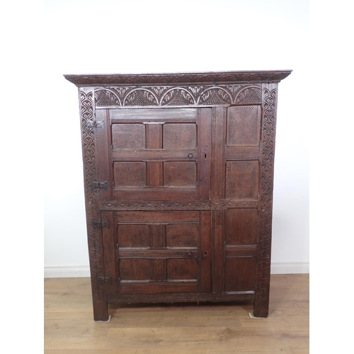 453 - A 17th Century and later oak ventilated Food Cupboard with carved cornice and frieze, two panelled c... 