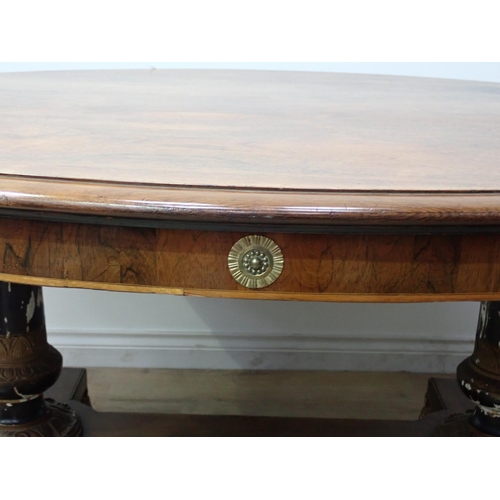 455 - A Regency rosewood Centre Table with moulded oval top, raised on cheval base of two painted and gild... 