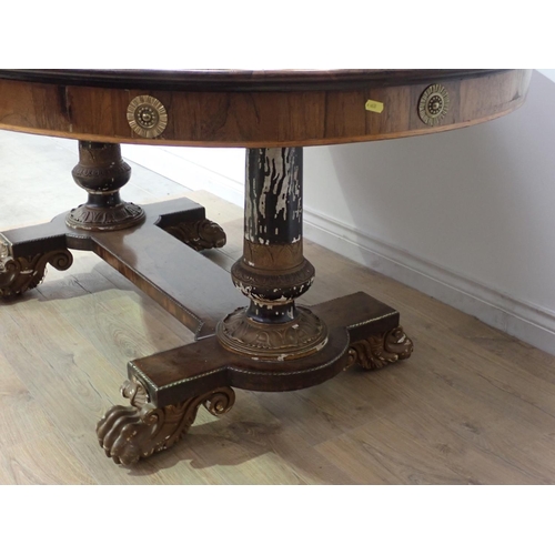 455 - A Regency rosewood Centre Table with moulded oval top, raised on cheval base of two painted and gild... 