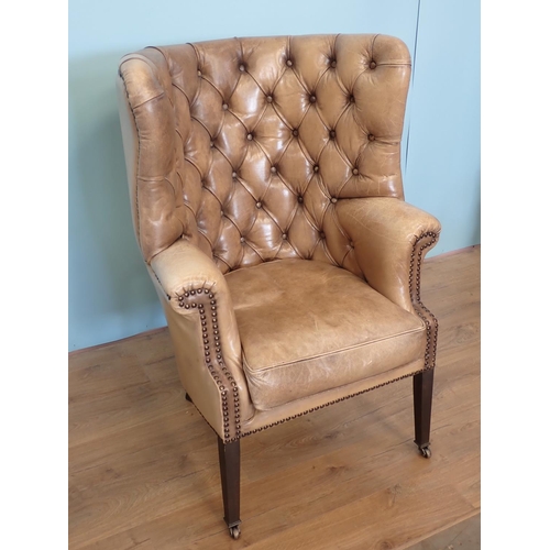 457 - A Georgian style button upholstered Library Chair with barrel-back, shaped arms, on squared tapering... 