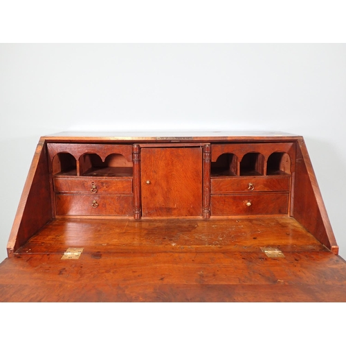 460 - An 18th Century elm Bureau, the interior fitted cupboard, drawers, pigeon holes and well, above two ... 