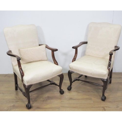 470 - A pair of mahogany framed Elbow Chairs with upholstered backs and seats on cabriole front supports a... 