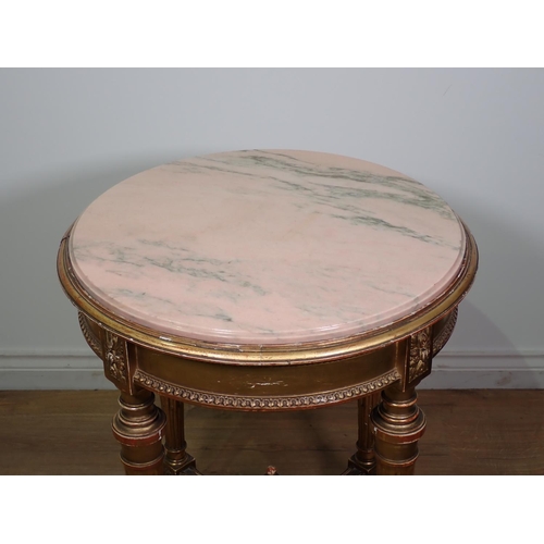 472 - A gilt circular Centre Table with pink veined marble top, the base with four fluted turned supports ... 