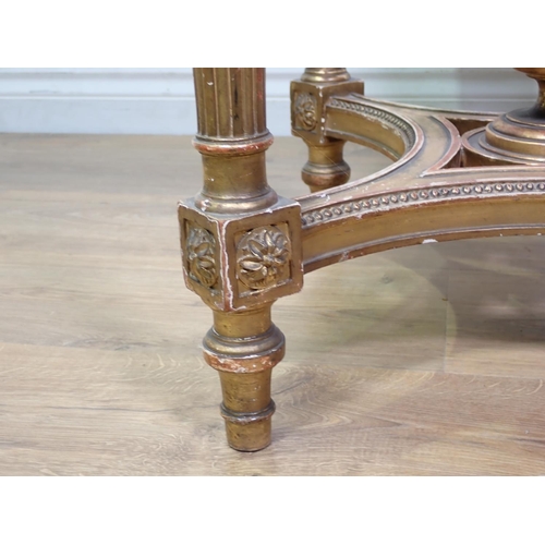 472 - A gilt circular Centre Table with pink veined marble top, the base with four fluted turned supports ... 