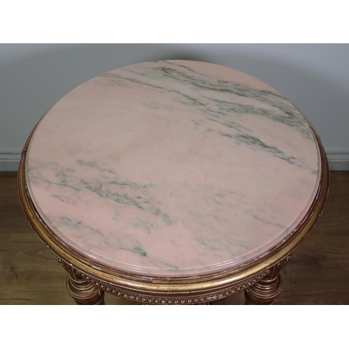 472 - A gilt circular Centre Table with pink veined marble top, the base with four fluted turned supports ... 