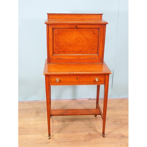 478 - A satinwood ladies Writing Desk by Maple & Co. with fall front, and fitted frieze drawer on squared ... 