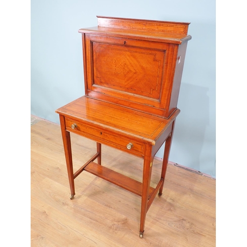 478 - A satinwood ladies Writing Desk by Maple & Co. with fall front, and fitted frieze drawer on squared ... 