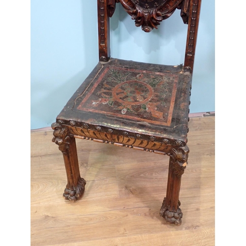 479 - A Continental walnut Chair in the 17th Century style with tooled leather armorial back panel, beneat... 