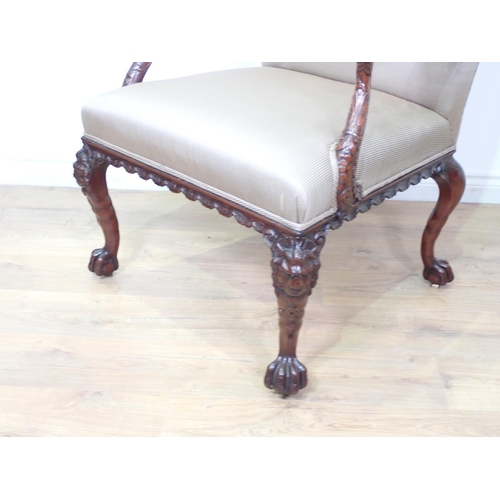 487 - A George II style carved mahogany Gainsborough Armchair, the shaped back and swept arms above a stuf... 