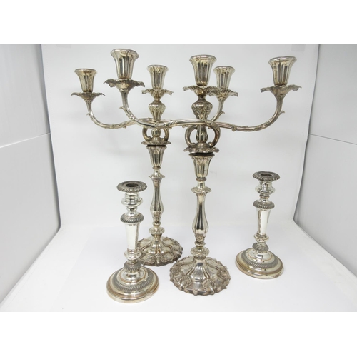 50 - A pair of Sheffield plated two-branch, three-light Candelabrum and a pair of plated Candlesticks on ... 