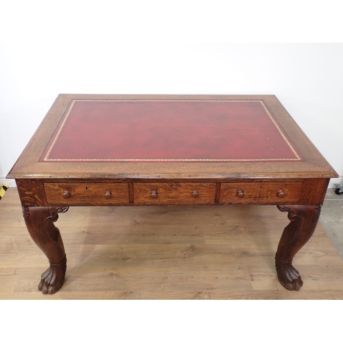 505 - A Victorian oak Library Desk with moulded top, inset writing surface fitted three frieze drawers and... 