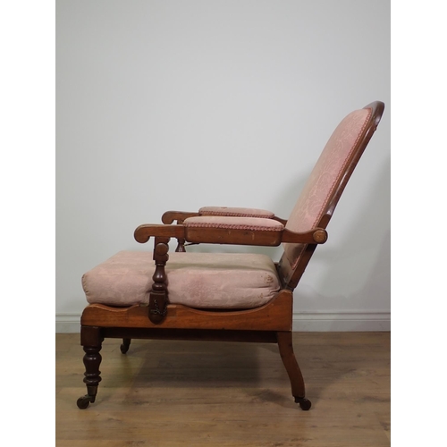 517 - A 19th Century folding Campaign Chair with shaped adjustable upholstered back, upholstered arm pads ... 