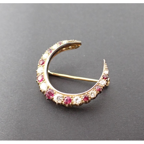 93 - A Ruby and Diamond Crescent Brooch pavé-set alternating round rubies and brilliant-cut diamonds, app... 