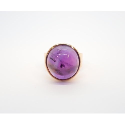 95 - An Amethyst Ring set oval cabochon to wide band in 14ct gold, ring size N