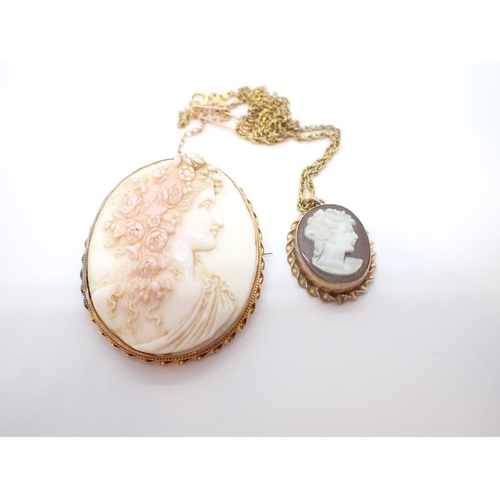 96 - A carved pink shell Cameo Brooch of bust in profile with flower adorned hair in ropetwist frame mark... 