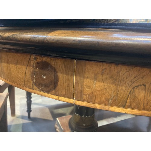 455 - A Regency rosewood Centre Table with moulded oval top, raised on cheval base of two painted and gild... 