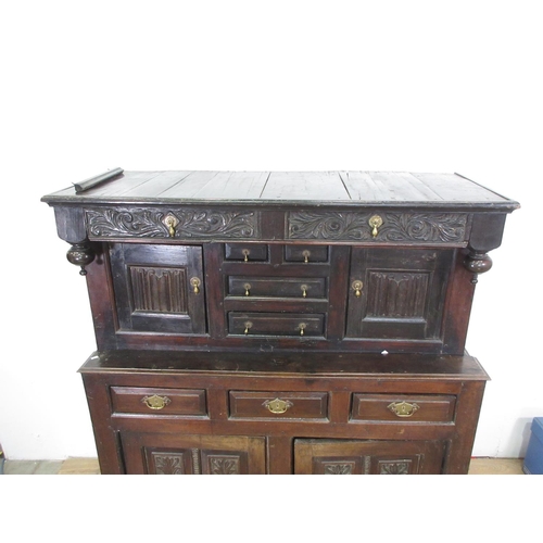 15 - An 18th Century oak Deudarn, the upper section fitted drawers and cupboards with linenfold carving, ... 