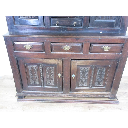 15 - An 18th Century oak Deudarn, the upper section fitted drawers and cupboards with linenfold carving, ... 