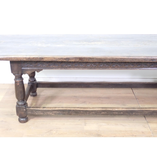 45 - A 17th Century style antique oak Refectory Table with plank top, on base with turned baluster suppor... 