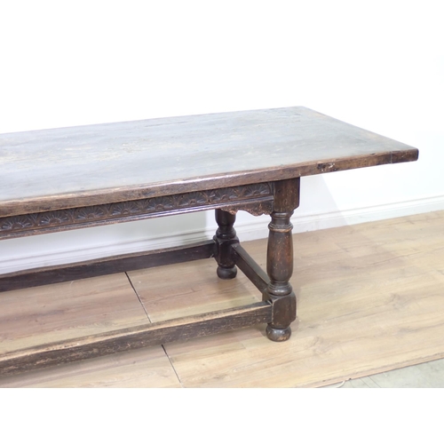 45 - A 17th Century style antique oak Refectory Table with plank top, on base with turned baluster suppor... 