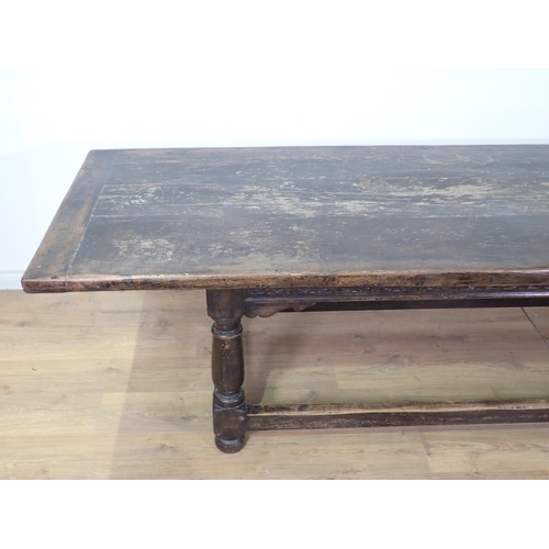 45 - A 17th Century style antique oak Refectory Table with plank top, on base with turned baluster suppor... 