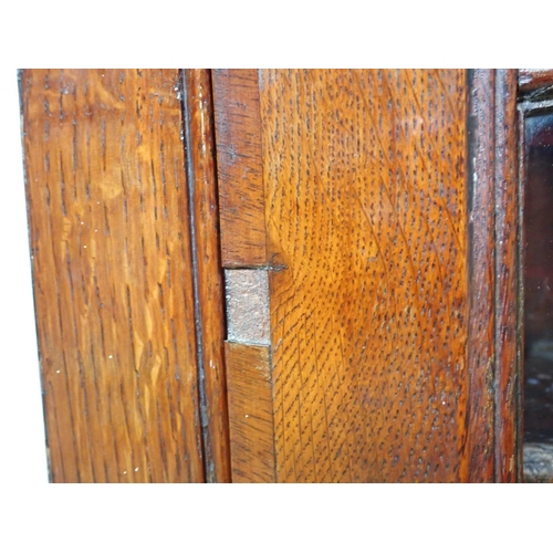 125 - An antique oak and glazed hanging Corner Cabinet 3ft 2in x 2ft 4in