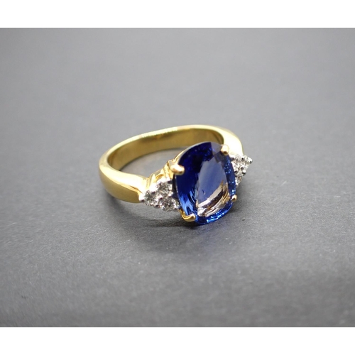 159 - A Sapphire and Diamond Ring claw-set oval-cut sapphire 3.08cts between trios of brilliant-cut diamon... 