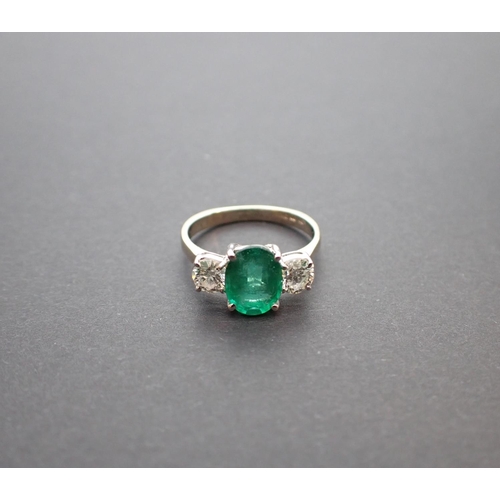 166 - An Emerald and Diamond three stone Ring claw-set oval-cut emerald, 1.71cts, between two brilliant-cu... 