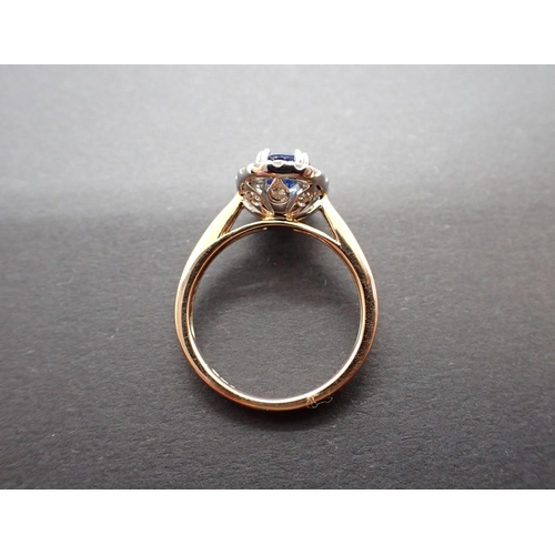 168 - A Sapphire and Diamond Cluster Ring claw-set oval-cut sapphire, 1.32cts, within a frame of pavé-set ... 