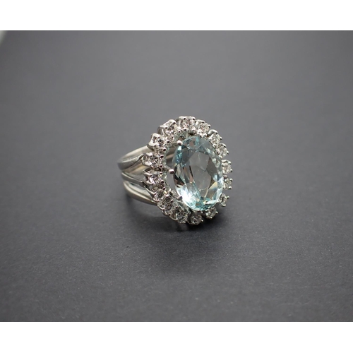 175 - An Aquamarine and Diamond Cluster Ring claw-set oval-cut aquamarine within a frame of brilliant-cut ... 