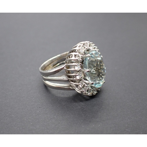 175 - An Aquamarine and Diamond Cluster Ring claw-set oval-cut aquamarine within a frame of brilliant-cut ... 