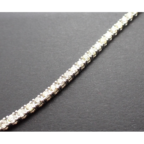 178 - A Diamond Tennis Bracelet having approx fifty nine articulated links each claw-set brilliant-cut sto... 