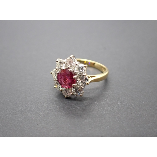 181 - A Ruby and Diamond Daisy Cluster Ring claw-set round ruby within frame of eight brilliant-cut diamon... 