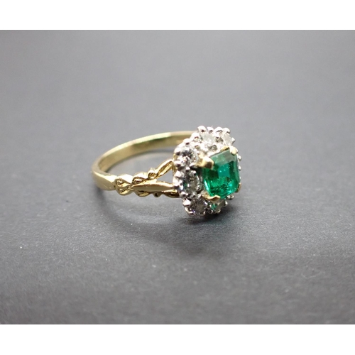 184 - An Emerald and Diamond Cluster Ring corner claw-set step-cut emerald within a frame of brilliant-cut... 