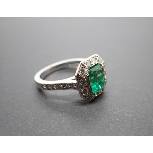 188 - An Art Deco style Emerald and Diamond Cluster Ring set step-cut emerald, 1.27cts, within a frame of ... 