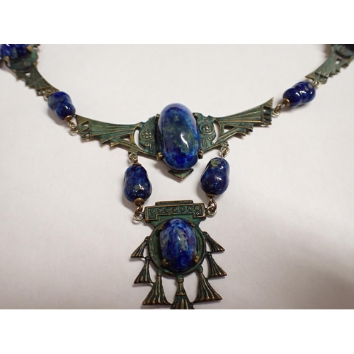 227 - An Art Deco Egyptian Revival Necklace having blue enamel beads and metal mounts