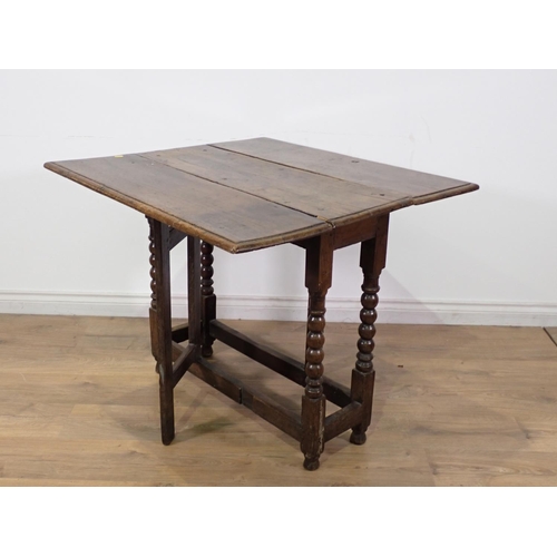 252 - A 17th Century oak Gateleg Table with rectangular moulded top mounted upon bobbin turned supports 2f... 